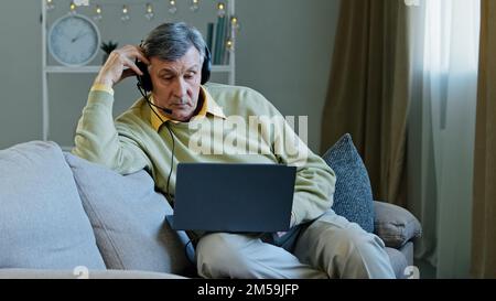 Older Caucasian male business entrepreneur man 60s senior agent mentor lawyer psychologist call service bank financial advisor online teacher in Stock Photo