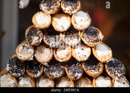 Close-up of sweets with chocolate and cream on display at a pastry shop in Venice, Italy. Selective focus Stock Photo