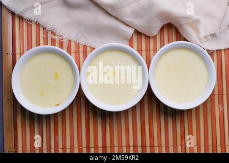 Caramel pudding in a glass jar on table  Stock Photo