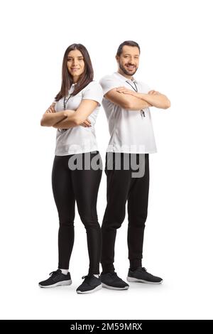 Full length portrait of a male and female sport coaches posing isolated on white background Stock Photo