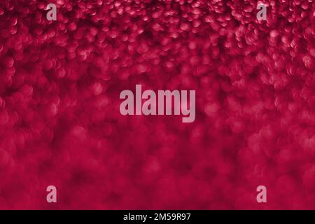 Trendy viva magenta, pink sparkling glitter bokeh background, abstract defocused texture. Holiday lights. Color of the year 2023 Stock Photo