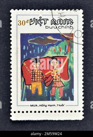 Cancelled postage stamp printed by Vietnam, that shows children's drawing, circa 1970s. Stock Photo