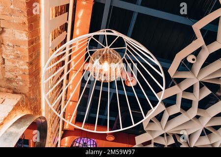 chandelier or luster with metal shade or lampshade and large retro lamp on blue ceiling. Stock Photo