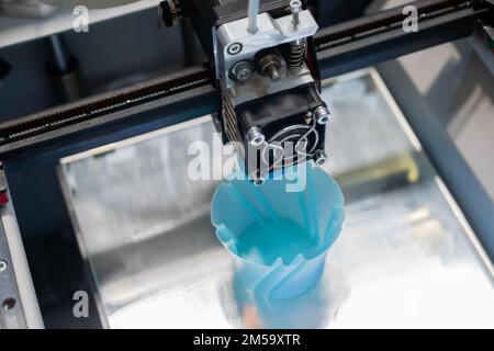 Three dimensional printing machine making blue physical 3D model - close up Stock Photo