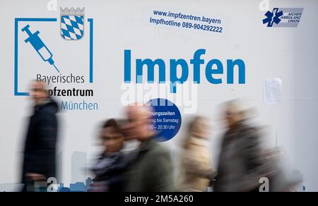 Munich, Germany. 27th Dec, 2022. Passers-by walk past a vaccination center on Marienplatz in the city center with the inscription 'Bayerisches Impfzentrum München - Impffen'. Credit: Sven Hoppe/dpa/Alamy Live News Stock Photo