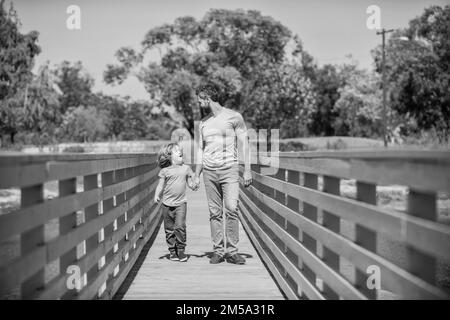 smiling father and son walking outdoor. family value. childhood and parenthood. Stock Photo