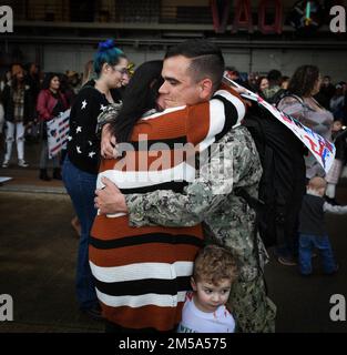 NAVAL AIR STATION WHIDBEY ISLAND, Wash. - Aviation Electronics Technician 1st Class Justin Rowe, assigned to the “Gauntlets” of Electronic Attack Squadron (VAQ) 136 greets his family after returning to Naval Air Station Whidbey Island, Washington, Feb 14, following an eight-month deployment to U.S. 3rd and 7th Fleet areas of operations as part of the Carl Vinson Carrier Strike Group. Stock Photo