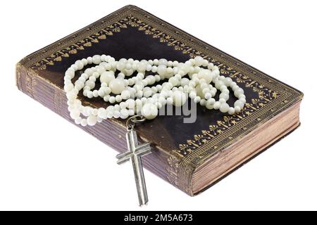 rosary on vintage common prayer book isolated on white background Stock Photo