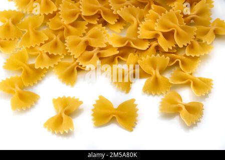 Dry uncooked italian bow tie shaped pasta called farfalle, isolated on white top view Stock Photo