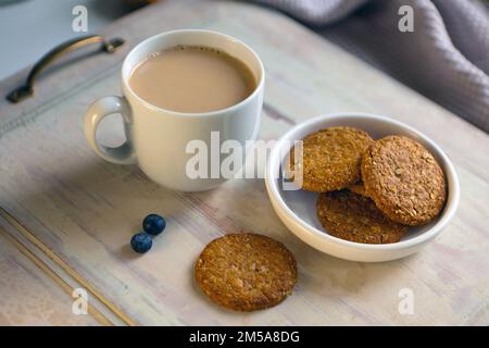 White cup of coffee with amaretti on light gray background with wooden table. aroma espresso mug Stock Photo