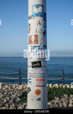 Stickers on a lampost along the promenade walkway on the seafront at the beach at Fanabe, Las Americas, Tenerife, Canary Islands, Spain Stock Photo