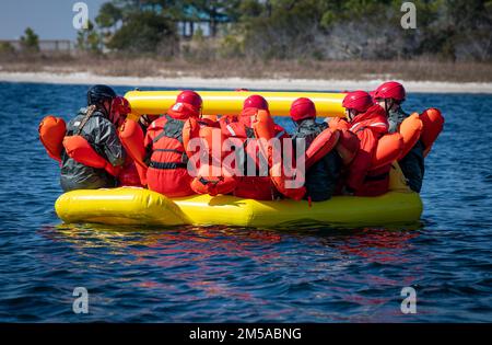 Water Survival Training participants board a life raft Feb. 15, 2022, at Hurlburt Field, Florida. The training is conducted by Survival, Evasion, Resistance and Escape specialists who educate flight personnel on how to handle water-based emergencies. Stock Photo