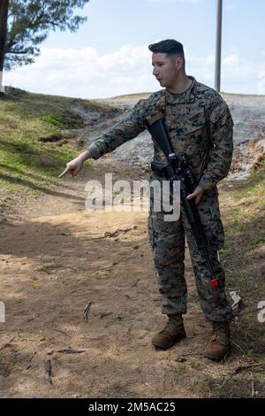 U.S. Marine Corps Sgt. Abraham Ortiz, a combat engineer with Combat Logistics Company Alpha, Combat Logistics Battalion 3, Combat Logistics Regiment 3, instructs Marines on patrolling and tactical unit movement during Jungle Warfare Exercise 22, Feb. 15, 2022, Kin Blue Beach, Okinawa, Japan. JWX is a large-scale field training exercise focused on leveraging the integrated capabilities of joint and allied partners to strengthen all-domain awareness, maneuver, and fires across a distributed maritime environment. CLC-A is forward-deployed in the Indo-Pacific under Combat Logistics Battalion 4. Stock Photo