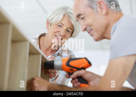 happy older couple holding diy tools Stock Photo