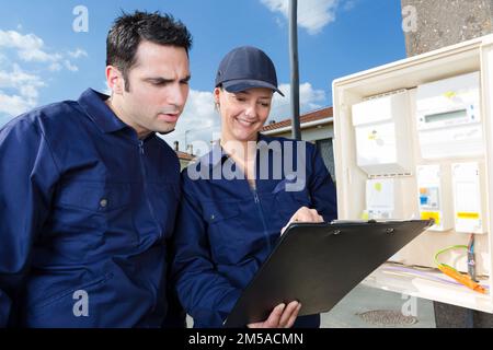 apprentice at work with engineer outdoors Stock Photo