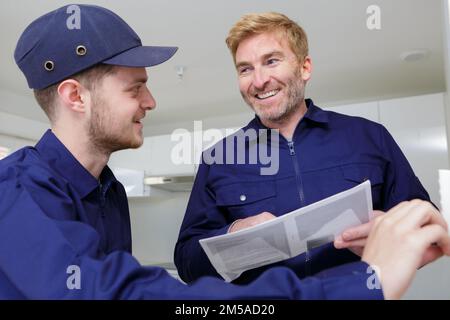 craftsman and young apprentice working together Stock Photo