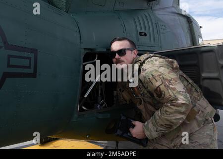 Tech. Sgt. John Griggs, 37th Helicopter Squadron flight engineer, completes a pre-flight check on his helicopter, February 15, 2022 on F.E. Warren Air Force Base, Wyoming. A pre-flight check is completed for the purpose of safety for the aircraft and the passengers. Stock Photo