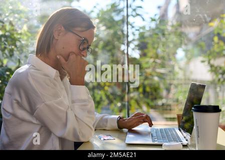 Woman architect, laptop and neck pain in stress, burnout or overworked at the office. Caucasian female employee suffering from neck ache, inflammation Stock Photo