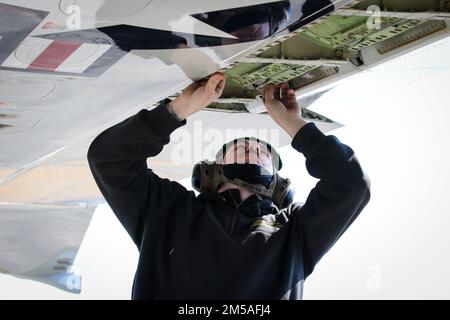 NAVAL AIR FACILITY ATSUGI, Japan (Feb. 16, 2022) – Aviation Machinist's Mate 1st Class Nathaniel Anderson, assigned to the “Golden Swordsmen” of Patrol Squadron (VP) 47, performs maintenance on the wing of a P-8A Poseidon during a Scheduled Maintenance Inspection (SMI) on the flight line at Naval Air Facility (NAF) Atsugi, Japan, Feb. 16, 2022. VP-47 is currently deployed to NAF Misawa, Japan conducting maritime patrol and reconnaissance and theater outreach operations within the U.S. 7th Fleet (C7F) area of operations in support of Commander, Task Force 72, C7F, and U.S. Indo-Pacific Command Stock Photo