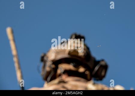 A Special Tactics combat controller with the 125th Special Tactics Squadron (STS), Oregon Air National Guard, works to coordinate the stack of aircraft flying overhead during a training exercise in Oklahoma City, Jan. 12, 2022. The stack was composed of a 137th Special Operations Wing MC-12W and an AC-130J Ghostrider assigned to Cannon Air Force Base, New Mexico. Stock Photo