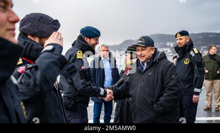 BERGEN, Norway (Feb. 16, 2022) — Secretary of the Navy Carlos Del Toro renders honors to the Norwegian flag and crew of HNoMS Thor Heyerdahl (F314), in Bergen, Norway, Feb. 16, 2022. Secretary Del Toro is in Norway to visit U.S. service members and Norwegian government leaders to reinforce existing bilateral and multilateral security relationships between the U.S. Navy and the Royal Norwegian Navy. Stock Photo