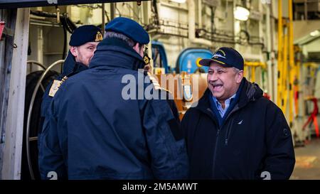 BERGEN, Norway (Feb. 16, 2022) — Secretary of the Navy Carlos Del Toro speaks with Norwegian Cmdr. Lars Ole Høknes, commanding officer of HNoMS Thor Heyerdahl (F314), center, and Rear Adm. Rune Andersen, Chief of the Royal Norwegian Navy, left, in Bergen, Norway, Feb. 16, 2022. Secretary Del Toro is in Norway to visit U.S. service members and Norwegian government leaders to reinforce existing bilateral and multilateral security relationships between the U.S. Navy and the Royal Norwegian Navy. Stock Photo