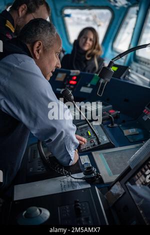 BERGEN, Norway (Feb. 16, 2022) — Secretary of the Navy Carlos Del Toro addresses the crew of HNoMS Thor Heyerdahl (F314) over the ship’s loudspeaker with Norwegian Cmdr. Lars Ole Høknes, commanding officer of Heyerdahl, in Bergen, Norway, Feb. 16, 2022. Secretary Del Toro is in Norway to visit U.S. service members and Norwegian government leaders to reinforce existing bilateral and multilateral security relationships between the U.S. Navy and the Royal Norwegian Navy. Stock Photo