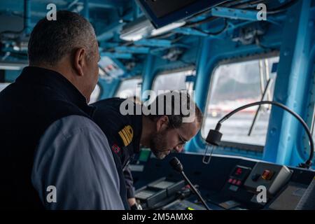 BERGEN, Norway (Feb. 16, 2022) — Secretary of the Navy Carlos Del Toro prepares to address the crew of HNoMS Thor Heyerdahl (F314) over the ship’s loudspeaker with Norwegian Cmdr. Lars Ole Høknes, commanding officer of Heyerdahl, in Bergen, Norway, Feb. 16, 2022. Secretary Del Toro is in Norway to visit U.S. service members and Norwegian government leaders to reinforce existing bilateral and multilateral security relationships between the U.S. Navy and the Royal Norwegian Navy. Stock Photo