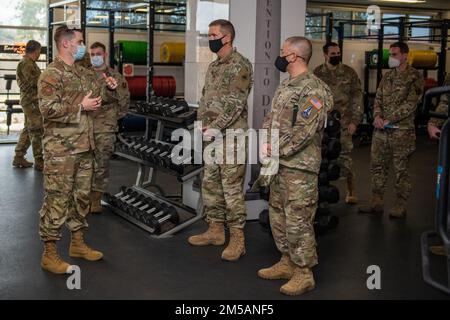 U.S. Air Force Tech. Sgt. Ryan Smith (left), Special Warfare Training Wing, physical medicine technician, briefs U.S. Space Force Brig. Gen. Shawn N. Bratton (center right), Commander, Space Training and Readiness Command and Chief Master Sgt. James P. Seballes (left), Space Training and Readiness Command, senior enlisted leader, during their visit to the SWTW, Feb. 16, 2022, Joint Base San Antonio-Chapman Annex, Texas. The STARCOM senior leaders learned how the SWTW combines research, technology integration, strength and conditioning, performance nutrition, physical and occupational therapy, Stock Photo