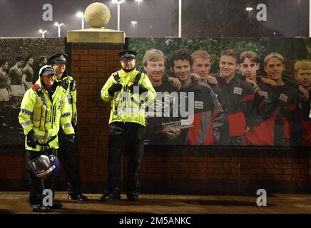 Manchester, England, 27th December 2022.  Police officers stand in front of a picture of former Manchester United players before the Premier League match at Old Trafford, Manchester. Picture credit should read: Darren Staples / Sportimage Stock Photo