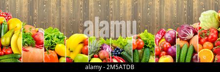 Colorful vegetables, fruits, berries on background of wooden boards. Stock Photo