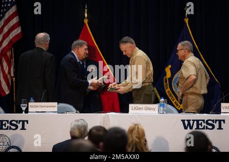 U.S. Marine Lt. Gen. Matthew G. Glavy, the deputy commandant for information, receives a book during the West 2022 Conference at the San Diego Convention Center in San Diego, California, Feb. 17, 2022. Throughout West 22, leaders from the Navy, Marine Corps and Coast Guard discussed modernization efforts and future concepts that support the Sea Services' operations. West 22 provides a venue for senior military and government officials to gain valuable direct feedback from operators and partners in the industry. Stock Photo