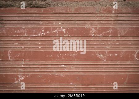 Detail of a brick wall with horizontal lines marked by orange bricks. Useful for copy space backgrounds Stock Photo