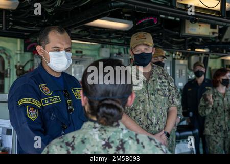 220217-N-GF955-1053  CARTAGENA, Colombia - (Feb. 17, 2022) -- Colombian navy Capt. Carlos Isaza, commanding officer of Naval Base ARC Bolivar, speaks to a Sailor assigned to the Freedom-variant littoral combat ship USS Billings (LCS 15) in the pilot house during a tour of the ship, Feb. 17, 2022. Billings is deployed to the U.S. 4th Fleet area of operations to support Joint Interagency Task Force South’s mission, which includes counter-illicit drug trafficking missions in the Caribbean and Eastern Pacific. Stock Photo