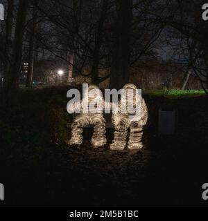 Light painting on two people on the bench in the park Stock Photo