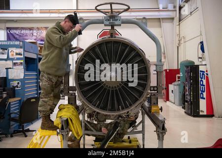 U.S. Air Force Staff Sgt. Tristan McDonald, an aerospace propulsion technician, assigned to the Ohio National Guard’s 180th Fighter Wing, inspects the engine of an F-16 Fighting Falcon at the 180FW in Swanton, Ohio, Feb. 17, 2022. The 180FW Propulsion Element was the first to implement a Pratt and Whitney 229 and 220 engine contract field team, providing war-ready engines to Combatant Commanders, in support of the Air Force and Air National Guard.  (U.S. Air National Guard by Staff Sgt. Kregg York) Stock Photo