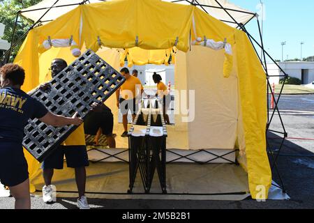 Sailors from Navy Medicine Readiness and Training Command Pearl Harbor set up a decontamination tent as part of the First Receiver Operations Training (FROT) held at Branch Health Clinic Makalapa on February 17, 2022. This yearly requirement teaches Sailors to properly decontaminate patients prior to administering medical care in the event of a Chemical, Biological, Radiological, or Nuclear (CBRN) incident. Stock Photo