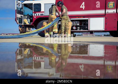 U.S. Airmen from the 6th Civil Engineer Squadron, operate a fire hose during a Major Accident Response Exercise (MARE) at MacDill Air Force Base, Florida, Feb. 17, 2022, The 6th CES Fire and Emergency Services flight trained to ensure response times during a simulated emergency scenario. Stock Photo