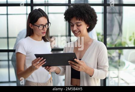 Two women analyzing documents office. Woman executives at work in office discussing some paperwork. Stock Photo