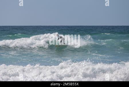 Padstow, Cornwall united kingdom September, 06 2012 Surfer riding on surfboard on ocean wave. Professional surfing in ocean on waves Stock Photo