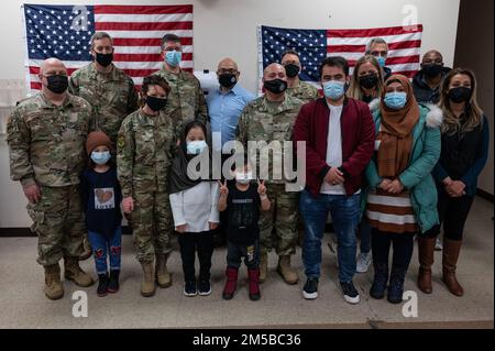 The Task Force Liberty leadership team poses for a photo with one of the last Afghan families to depart Liberty Village at Joint Base McGuire-Dix-Lakehurst, New Jersey, Feb. 19, 2022. The guests were the last departures to complete their resettlement from Task Force Liberty. The Department of Defense, through U.S. Northern Command, and in support of the Department of Homeland Security, is providing transportation, temporary housing, medical screening, and general support for at least 11,000 Afghan evacuees at Liberty Village, in permanent or temporary structures, as quickly as possible. This i Stock Photo