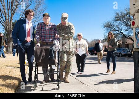 Dallas Texas -- Texas National Guardsman from 36th Sustainment Brigade do their part in granting the wish of 101 year-old WWII veteran, Jim Niederer, with a ride along in a military truck, Saturday Feb. 19, 2022. Mr. Niederer is a well decorated WWII Soldier from the 36th Infantry Division; surviving beach invasions, German Shelling and liberating concentration camps. He ran supplies to the front lines in six-by-six trucks and his wish was to ride in a military truck one more time. Stock Photo