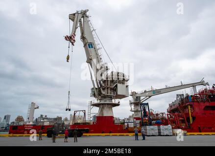 OKINAWA, Japan (Feb. 20, 2022) Sailors assigned to Naval Mobile Construction Battalion (NMCB) 3 transports equipment onto the U.S. Navy-contracted diving support vessel (DSCV) Picasso to support recovery of the F-35C Lightning II aircraft that crashed during routine flight operations in the South China Sea, Jan. 24. NMCB-3 is assigned to Commander, Task Force (CTF) 75. CTF 75 and the NAVSEA’s Supervisor of Salvage and Diving (SUPSALV) are embarking Picasso to oversee the safe recovery of the aircraft. Stock Photo