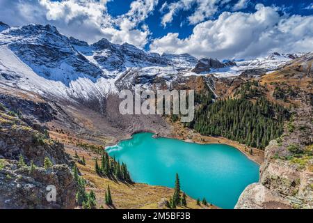 An epic view from a ledge high above Lower Blue Lake in the Mount Sneffels Wilderness near Telluride, Colorado. Stock Photo