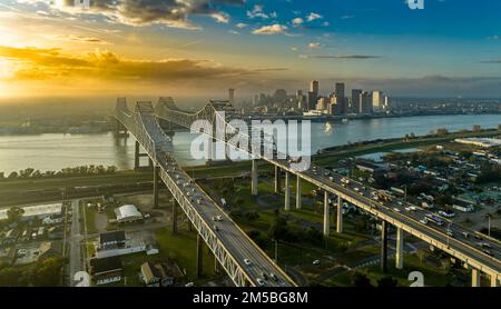 Aerial sunset view of the Crescent City Connection bridge over the Mississippi river in New Orleans Louisiana Stock Photo