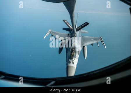 A U.S. Air Force F-16 Fighting Falcon receives fuel from a U.S. Air Force KC-135 Stratotanker above an undisclosed location over Southwest Asia, Feb. 23, 2022. The KC-135 delivers Ninth Air Force (Air Forces Central) a global reach aerial refueling capability to support joint and partner nation aircraft throughout the U.S. Central Command area of responsibility. (Photo by Staff Sgt. Frank Rohrig) Stock Photo