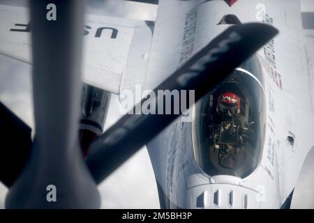 U.S. Air Force Maj. Ryan 'Slinga' Yingling, U.S. Air Force Air Demonstration Squadron 'Thunderbirds' opposing solo pilot, approaches a KC-135 Stratotanker assigned to MacDill Air Force Base, Florida, for refueling over the Southwestern United States, Feb. 22, 2022. The Thunderbirds flew from Daytona, Florida, back to Nellis AFB, Nevada, after performing a fly-over at the Daytona 500. Stock Photo