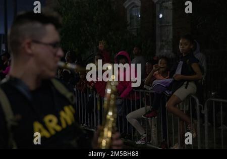 (Mobile, AL) — The crowd cheers for the 151st Army Band from Montgomery, during their performance in the Order of the LaShe’s Mardi Gras parade, Feb 22nd, 2022. The band played in various parades around coastal Alabama. Mobile holds nearly nightly parades during the Mardi Gras season with most parades attracting crowds as large as 10,000 people. Stock Photo