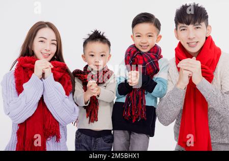 Happy asian family showing congratulation gesture for celebrating Chinese new year Stock Photo