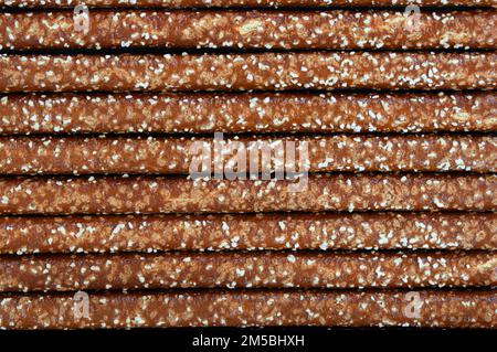 Straight pretzel sticks lined up, background Stock Photo